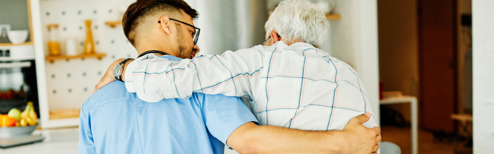 Doctor or nurse caregiver helping senior man holding walking cane at home or nursing home