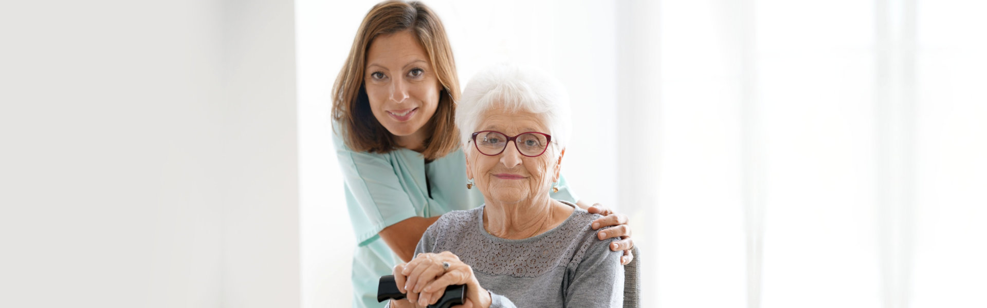 Nurse visiting senior woman at home